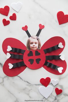 a lady bug made out of paper with hearts on the side and a photo cut out into