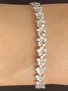 Elegant And Beautiful Hawaiian 14K Solid White Gold 6mm Plumeria Flowers Lei Bracelet 7 1/4 Inches Diamond Cut on the edges of each petal. 14 Karat Solid White Gold GUARANTEED, Authenticated with a 14K Stamp Made With the Highest Quality Craftsmanship Solid 14K White Gold Plumeria Flowers Lei Bracelet Total Weight 6.6 grams Solid 14K Yellow Gold Plumeria Flower Width 6 Millimeters Bracelet Length 7.25 Inches Amazing! Gift For Family And Friends! A Bracelet Jewelry Gift Box Included! Gold Flower Bracelet, Jewelry White Gold, Plumeria Flowers, Hawaiian Jewelry, Wedding Jewelry Bracelets, Classy Jewelry, White Gold Jewelry, Layered Bracelets, Gorgeous Bracelet