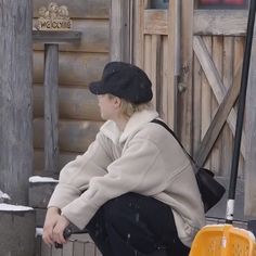 a person sitting on a bench in the snow