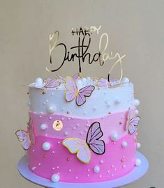 a birthday cake decorated with butterflies and the words happy birthday written on top in gold lettering