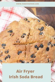 an air fryer irish soda bread on a red and white checkered napkin with the words air fryer irish soda bread