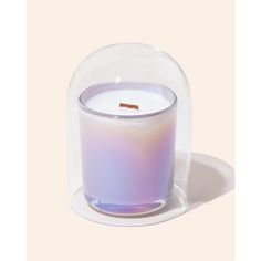 a glass candle holder with a purple liquid inside