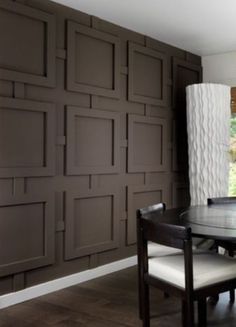 a dining room table and chairs with brown walls