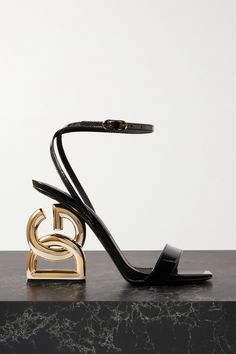 There's no mistaking who these 'Keira' sandals were designed by – Dolce & Gabbana make a sculptural statement with the gold-tone heels. They're crafted from glossy patent-leather and have slim straps running across the toes and ankle. Wear yours with a strapless column-shaped gown and red lipstick.