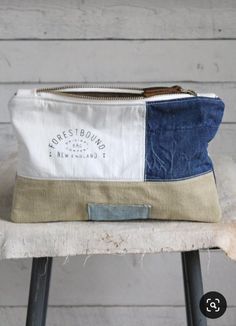 a white and blue bag sitting on top of a chair