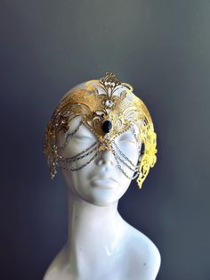 Step into the realm of goddesses with our women's masquerade mask in gold. Rhinestones delicately embellish the mask, adding a touch of sparkle. Silver chains gracefully adorn the mask, creating an enchanting movement. Capture attention at any masquerade party, ball, or themed event!


Age Group/Gender - Adult/Women

Size/Type - One size fits all adults

Mask Color - Gold

Mask Material - Laser Cut Metal

Special Features - Chains and rhinestones Gold Adjustable Masquerade Mask, Adjustable Gold Mask For Masquerade, Gold Adjustable Masks For Masquerade, Adjustable Gold Masks For Masquerade, Mystical Crown Headpiece For Masquerade, Gold Fantasy Headpieces For Masquerade, Gold Eye Mask For Costume Party, Gold Masks For Evening Carnival, Adjustable Crown Headpiece For Masquerade