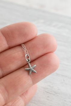 Tiny sterling silver starfish necklace. These creatures have been mesmerizing sea farers and beach combers for as long as they've graced the oceans. Perfect for your beach wedding bridal party! Make your necklace extra special by personalizing it with one of our sterling silver birthstone or initial charms. Available with or without birthstone charm. ✥ Sterling silver.✥ 11mm x 8.5mm charm✥ Sterling silver chain 16" or 18"✥ Beautifully packaged and ready for giving✥ Gift wrap available at checkou Affordable Silver Starfish Necklace, Beach Bridesmaids Gifts, Beach Bridesmaids, Sand Dollar Necklace, Tiny Creatures, Lover Necklace, Star Charm Necklace, Beach Lover Gifts, Lovers Necklace