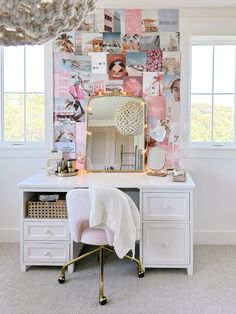 a white desk topped with a mirror and a pink chair next to a wall covered in pictures