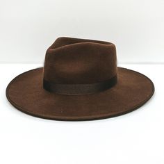 A dark brown felt hat with a ribbon band pictured on a white background. Lack Of Color, Crown Heights, Wool Fedora, Ordinary Day, Bow Ribbon, Crown Design, Hat For Man, Felt Hat, Grosgrain Ribbon