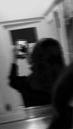 a blurry image of a woman taking a selfie