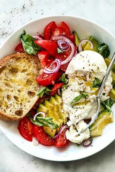 a white bowl filled with salad and bread