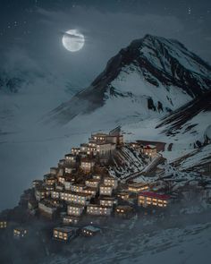 an image of a mountain town at night with the moon in the sky above it