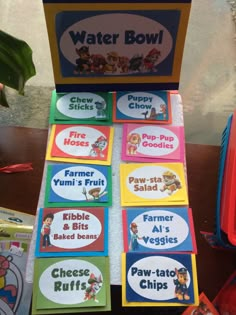 several children's water bowls are stacked on top of each other with labels for them