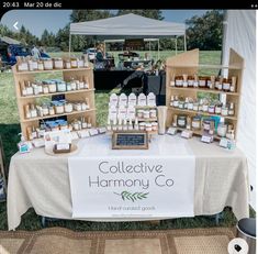 a table with many items on it under a tent at an outdoor market selling products