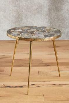 the table is made out of wood and has a marble top