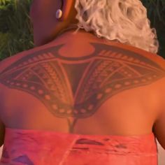 the back of a woman's body with tattoos on it