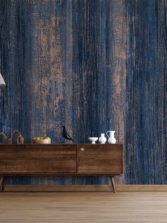 a wooden table with two vases on it next to a lamp and wallpaper