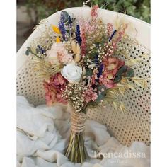 a bouquet of flowers sitting on top of a white chair