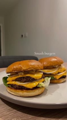 two cheeseburgers sitting on top of a white plate