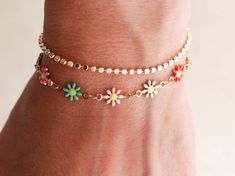 The most anticipated chain from our followers! The Daisy chain is made up of adorable, enamel coated daisies in pink, white, or the colorful multi. This bracelet stacks well with other chains in our shop or looks great worn by itself, we love it with the dot, herringbone and pearl bracelets. Bracelets come with an extender for an adjustable fit. Made with waterproof materials - 18k gold electroplated stainless steel, 14k gold filled clasp and extenders.Lengths: 5" + 1" extender (child)6" + 1" ex Cute Spring Bracelet Jewelry, Cute Multicolor Spring Jewelry, Playful Adjustable Jewelry For Spring, Playful Adjustable Spring Jewelry, Daisy Chain Bracelet, Bracelet Stacks, Pearl Bracelets, The Dot, Daisy Chain