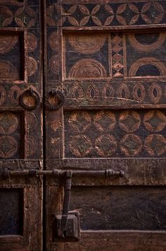 an old wooden door with intricate designs on it