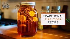 a jar filled with liquid sitting on top of a wooden counter