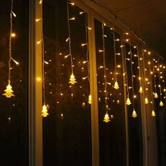 christmas lights hanging from the side of a window