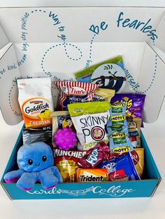 a blue box filled with candy and snacks