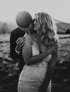 black and white photo of a bride kissing her groom