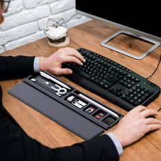 a man sitting at a desk with a keyboard and mouse