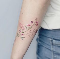 a woman's arm with flowers on it and the words eva tattooist dessolde papa