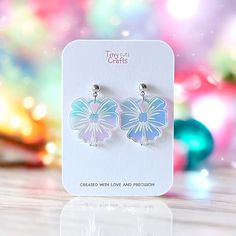 Bow earrings made from holographic iridescent acrylic, perfect for adding a fun and stylish touch to any Christmas outfit or daily wear. These cute bow dangles shimmer beautifully in the light, making them ideal for both casual wear and special occasions. Lightweight and comfortable, they are designed to make a statement while remaining easy to wear all day.  Perfect for those who love playful accessories or as a unique gift. Made with stainless steel findings for sensitive ears, available with two options: hooks or ball posts in gold tone or silver. Measuring approximately 1.25 to 1.50 inches depending on the findings chosen. Earrings come in a gift bag with a polishing cloth:) safely packaged in a shipping box.  Please contact me with any questions. Trendy Iridescent Jewelry For Gifts, Holographic Iridescent, Iridescent Acrylic, Earrings Christmas, Bow Earrings, Cute Bow, Christmas Earrings, Acrylic Earrings, Cute Bows