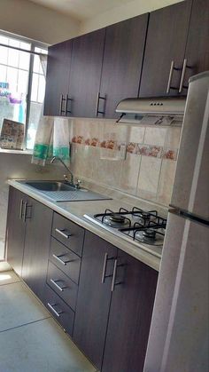 a kitchen with wooden cabinets and stainless steel appliances