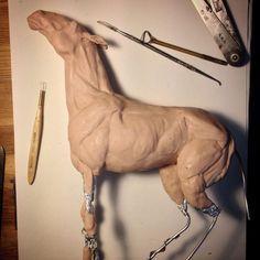 the horse is made out of clay and has tools on it's back end