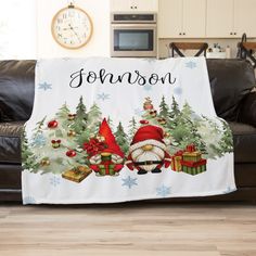 personalized christmas blanket with santa claus and gifts on it in front of a couch