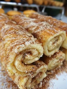 some food that is sitting on a white plate with sugar sprinkled around it