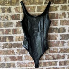 Forever 21 Black Bodysuit Size Small Shell: 100% Polyurethane Backing: 94% Polyester, 6% Spandex Snap Closure Forever 21 Fitted Bodysuit, Forever 21 Trendy Black Bodysuit, Fitted Forever 21 Bodysuit For Night Out, Barbie Bodysuit, Yellow Bodysuit, Tank Top Bodysuit, Strapless Bodysuit, Mock Neck Bodysuit, Scoop Neck Bodysuit