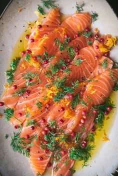 a plate with salmon and garnish on top of it, ready to be eaten