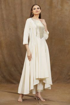 Ivory kurta with gota patti embellished patterns. Comes with matching pant.
Components: 2
Pattern: Embroidered
Type Of Work:  Gota
Neckline: Round
Sleeve Type: Full
Fabric: Organic Cotton
Color: Ivory
Other Details: 
Asymmetric hem
High low kurta
Occasion: Puja,
Mehendi and Haldi - Aza Fashions Elegant Cotton Anarkali Set With Gota Work, Elegant Cotton Sharara With Gota Work, Elegant Cream Cotton Anarkali Set, Elegant Cotton Sharara With Mirror Work, Diwali Off White Palazzo Set, Elegant Cotton Sharara With Cutdana, Cream Cotton Palazzo Set For Wedding, Cream Gota Work Kurta For Reception, Off White Cotton Palazzo Set With Zari Work