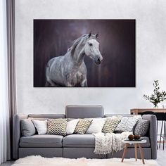 a white horse running through the air in a living room