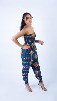 Turn heads this summer with this stunning Ankara Strapless Jumpsuit, an effortlessly chic and vibrant piece that perfectly captures the essence of modern African fashion. This jumpsuit is designed for women who appreciate unique, culturally inspired styles while staying on trend. Made from top-quality, 100% cotton Ankara fabric, this jumpsuit showcases a bold and vibrant blue disk pattern. The fabric is not only visually striking but also breathable and comfortable, making it ideal for warm-weat Casual Fitted Strapless Jumpsuits And Rompers, Casual Beach Strapless Jumpsuit, Casual Strapless Jumpsuit For Beach, Casual Strapless Jumpsuit For The Beach, Trendy Blue Strapless Jumpsuits And Rompers, Casual Bandeau Strapless Jumpsuit For Beach, Strapless Jumpsuits And Rompers For Vacation, Trendy Strapless Denim Jumpsuit, Strapless Fitted Jumpsuits And Rompers For Beach