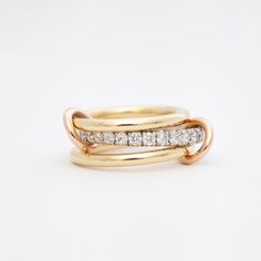 Like love itself, this ring is pure and enchanting. A trio of alternating yellow and white gold bands are joined with rose gold connectors for a full spectrum of mixed metals. The wider center band is covered in white diamond pavé for a classic sparkle in a modern look. Wear it stacked to frame the diamonds or flip one band over to let the stones shine even brighter. Made in the U.S.A. Bands measure 2.3 mm, 2.8, and 2.3 mm wide. Fully assembled stack measures approximately 8.5 mm wide. All sizes Band Necklace, Signature Rings, Rose Gold Accents, Fancy Nancy, Diamonds And Gold, Band Engagement Ring, White Gold Band, Timeless Jewelry, Full Spectrum