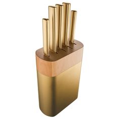 a golden knife block with six knives in it