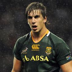 a rugby player with his mouth open in the rain