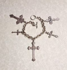 This is a for a vintage, cross charm bracelet. All the crosses are different.  It is unsigned and has not been cleaned. It has usual wear and tear for the age. The photos don't always depict the true color. I took several pictures so you could see clearly the condition they are in. If you have any questions, or problems with an order please contact me. I sell an item as is, but I will work to resolve any issues a customer may have with a purchase. My items are used so many have imperfections. This item has free shipping. Religious Cross, Cross Charms, The Age, Charm Bracelets, Vintage Silver, True Colors, Jewelry Bracelets, Im Not Perfect, Charm Bracelet