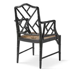 a black chair with wicker seat and armrests on an isolated white background