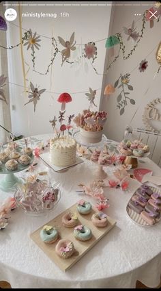 a table topped with lots of cakes and cupcakes