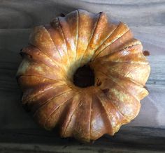 a round pastry sitting on top of a wooden table