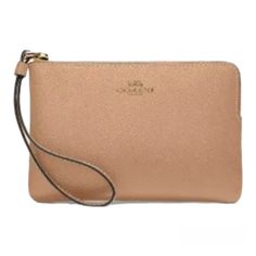 This Beautiful Coach Wristlet Is Perfect For Any Occasion. Crafted From High-Quality Leather, This Wristlet Features A Stylish Gold/Taupe Color With A Solid Pattern And Metal Accents. The Convenient Corner Zip Design Provides Easy Access To Your Credit Cards And Other Essentials While On The Go. With Its Compact Size And Versatile Style, This Wristlet Is A Must-Have Accessory For Any Fashion-Forward Woman. Whether You're Running Errands Or Hitting The Town With Friends, This Coach Wristlet Adds Beige Clutch For Daily Use, Coach Beige Bag With Zipper Pouch, Beige Rectangular Wristlet For Travel, Everyday Coach Leather Wristlet, Everyday Coach Clutch, Elegant Beige Clutch With Wrist Strap, Coach Beige Pouch Wristlet, Beige Coach Pouch Wristlet, Coach Clutch For Daily Use