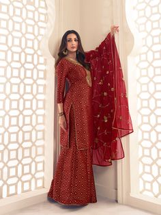 This Malaika Arora Maroon Zari Woven Yoke Design Embroidered Straight Kurta set features true craftsmanship in a luxurious silk blend design. Embellished with intricate Zari, this sharara is perfect for ethnic events and winter parties. Ready-to-wear, it features a round neck and three-quarter sleeves, with side slits for extra comfort. Grandeur and majestic artwork is attributed to this exquisite creation by Malaika Arora. TOP: Silk Blend(Brocade), TOP INNER: Cotton, BOTTOM: Silk Blend(Brocade) Festive Unstitched Anarkali Set With Resham Embroidery, Unstitched Palazzo Set With Resham Embroidery And Straight Kurta, Straight Kurta Sets With Resham Embroidery In Chinon, Chinon Straight Kurta Sets With Resham Embroidery, Chanderi Palazzo Set With Resham Embroidery For Diwali, Festive Designer Palazzo Set With Dabka Work, Designer Bollywood Sharara With Resham Embroidery, Semi-stitched Floor-length Kurta With Resham Embroidery, Bollywood Style Festive Palazzo Set With Resham Embroidery